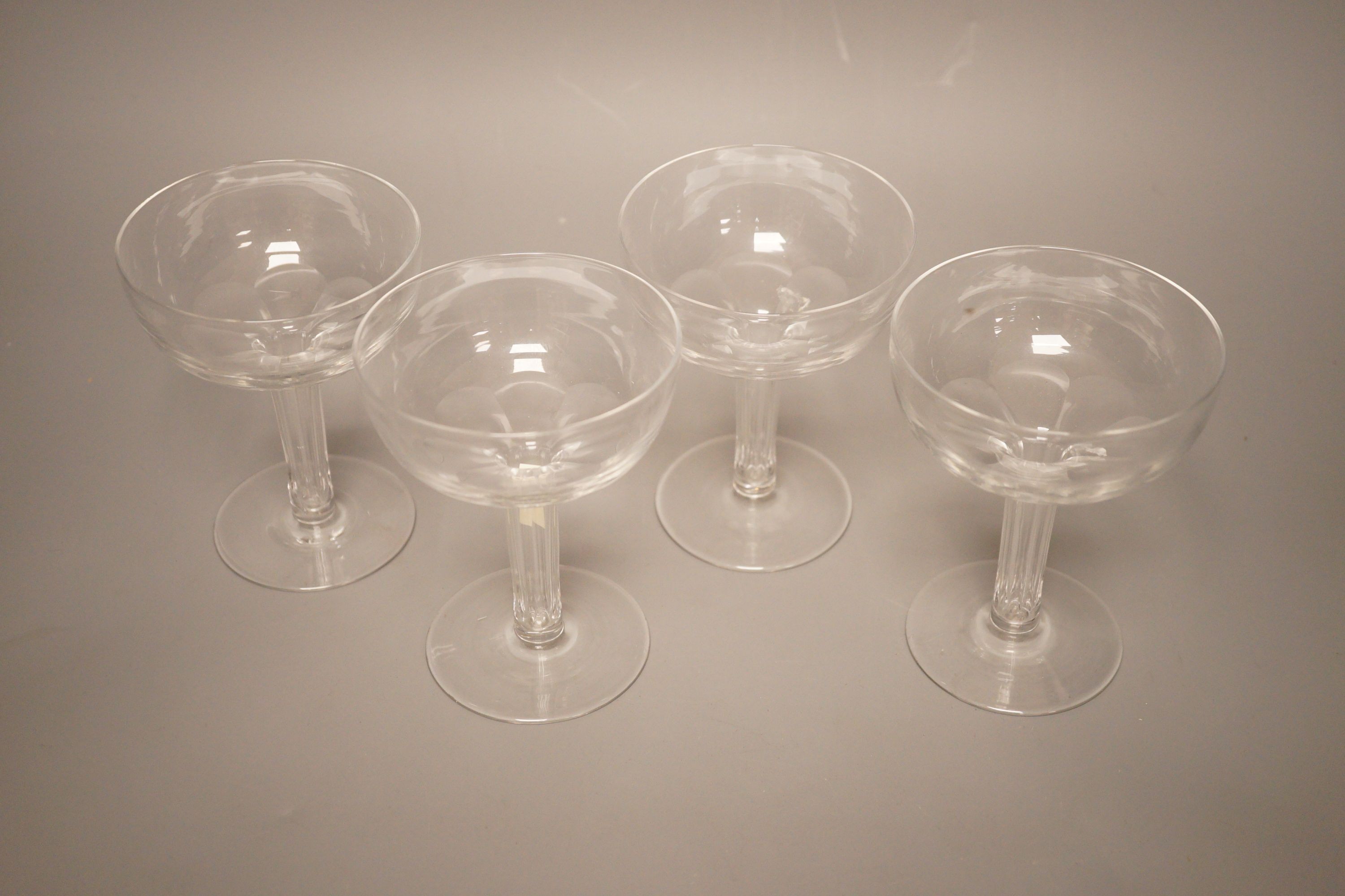 A set of four facet cut hollow stemmed champagne glasses
